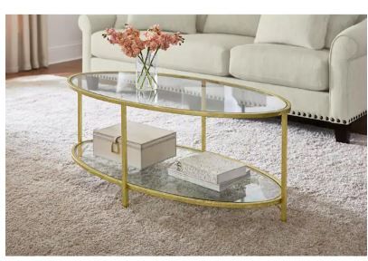 Photo 1 of Bella Large Oval Gold Metal and Glass Coffee Table with Shelf (46 in. W x 18 in. H
