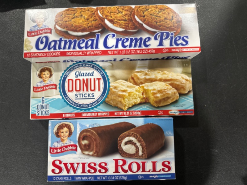 Photo 1 of Little Debbie Oatmeal Creme Pies, 12 Individually Wrapped creme pies, 16.2 Ounces, Pack of One (1)  & Little Debbie Donut Sticks, 6 Individually Wrapped Snack Cakes, 10 oz, Pack of one (1) 10 Ounce (Pack of 1) & Little Debbie Swiss Rolls - 12 cakes, 13 oz
