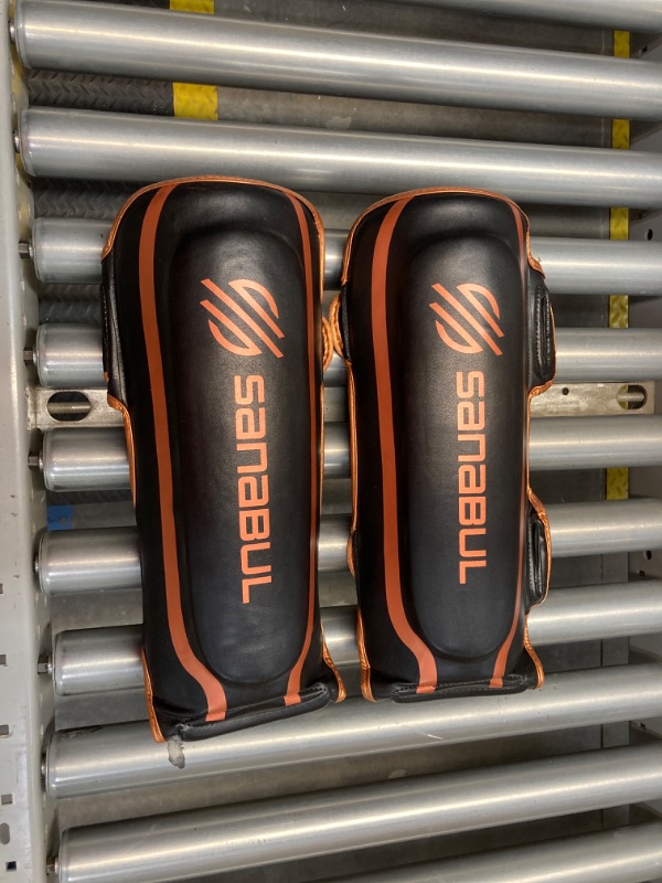 Photo 2 of Sanabul Essential Kickboxing Shin Guards with Hook & Loop Straps | Pro-Tested & Versatile Shin Pads for MMA, Muay Thai, and Kickboxing - Tailored for Comfort and Mobility, Small, Metallic Copper