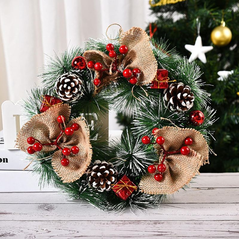 Photo 1 of  Snow Flocked Christmas Wreath 12'' Artificial Winter Front Door Wreath Pinecones Mixed Decoration Outdoor Xmas Tree Garland for Holiday New Years Indoor Wall Window Fireplace Decorations