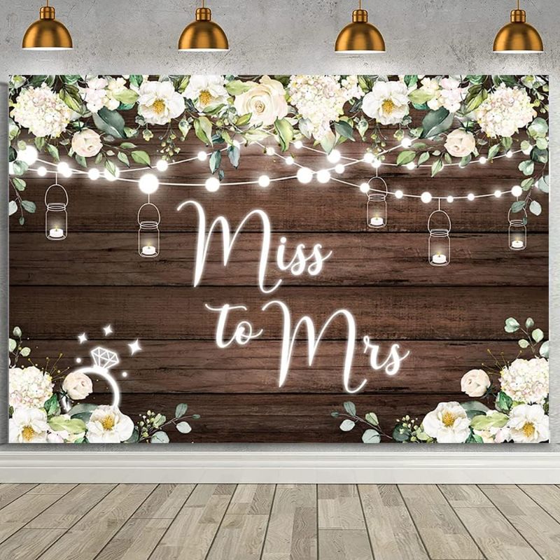 Photo 1 of AIBIIN 7x5ft Miss to Mrs Backdrop for Bridal Shower White Floral Glitter Lights Rustic Brown Wood Wall Wedding Bride to Be Engagement Party Photography Background Decor Photo Booth Prop
