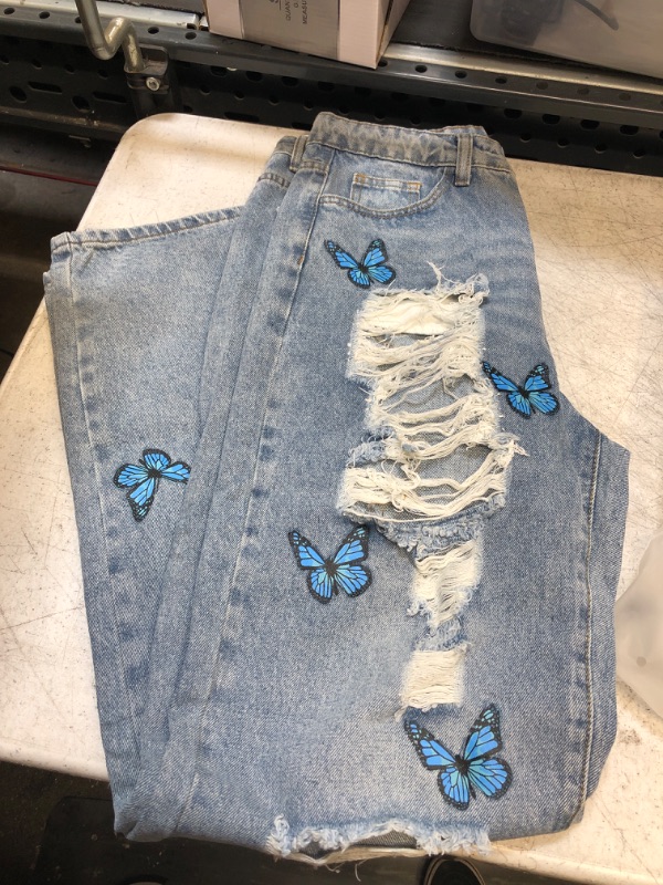 Photo 1 of light wash ripped jeans- butterfly 
size- large