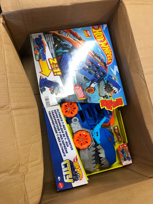 Photo 2 of Hot Wheels City Ultimate Hauler, Transforms into Stomping T-Rex with Race Track, Lights and Sounds, Toy Storage for 20+ 1:64 Scale Cars