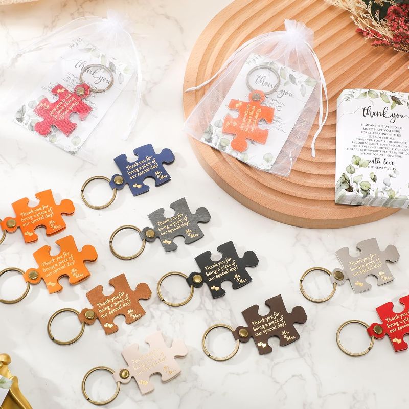 Photo 1 of 100 Sets Wedding Favors for Guests Wedding Puzzle PU Leather Keychain Thank You Card Organza Bag Wedding Souvenirs Return Gift