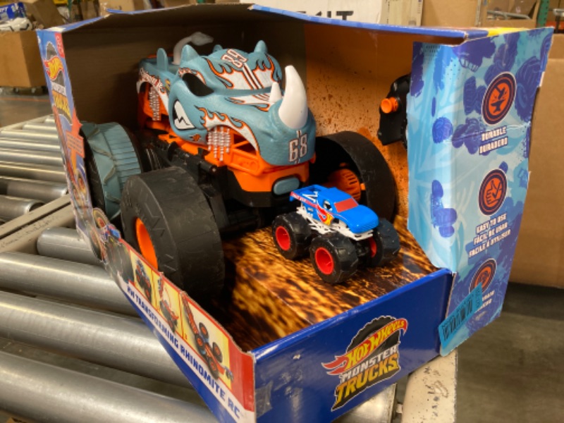 Photo 1 of Hot Wheels Monster Trucks HW Transforming Rhinomite RC in 1:12 Scale with 1:64 Scale Race Ace Toy Truck, Converts into Launcher, Connects to Orange Track