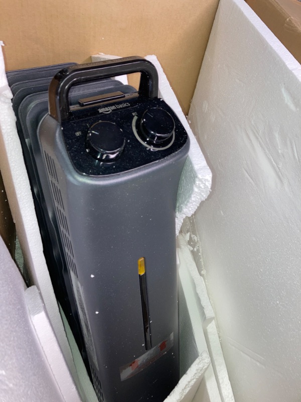 Photo 1 of Amazon Basics Portable Radiator Heater with 7 Wavy Fins, Manual Control, Black, 1500W, 13.1 x 26.3 x 9.8 in
