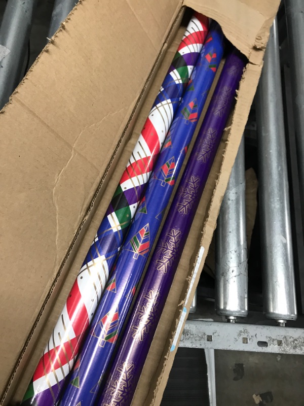 Photo 1 of Hallmark Modern Christmas Wrapping Paper with Cutlines on Reverse (3 Rolls: 120 Sq. Ft. Total) Gold Snowflakes on Purple, Jewel-Tone Trees, Plaid Stripes Jewel Tone Purple, Gold, Red, Blue, Green
