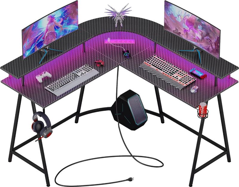 Photo 1 of  SUPERJARE L Shaped Gaming Desk with Power Outlets & LED Lights, Carbon Fiber Surface, Computer Desk with Monitor Stand, Home Office Desk Corner Desk with Cup Holder & Hooks, Black SuperJare SKU#7937bc
