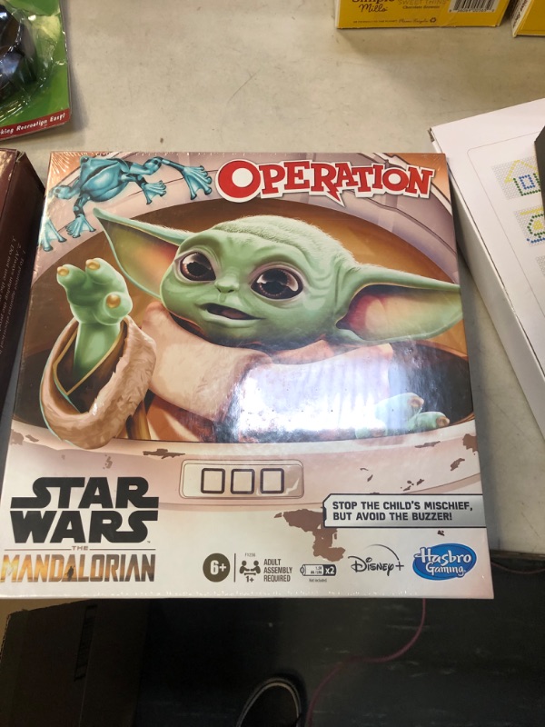 Photo 2 of **DAMAGED BOX** Hasbro Operation Game: Star Wars The Mandalorian Edition Board Game for Kids Ages 6 and Up, The Child who Fans Call Baby Yoda is Causing Mischief, English Version factory sealed 