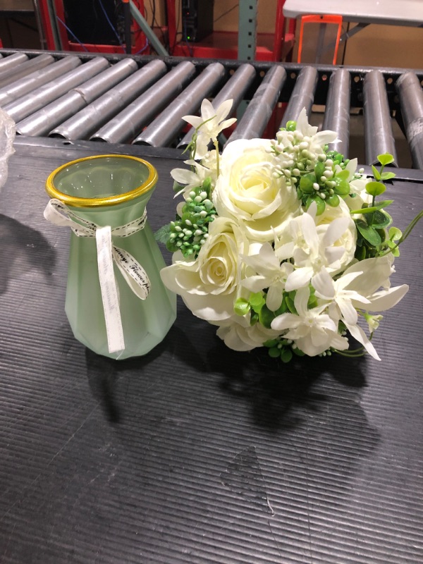 Photo 1 of flower vase with artificial flowers.