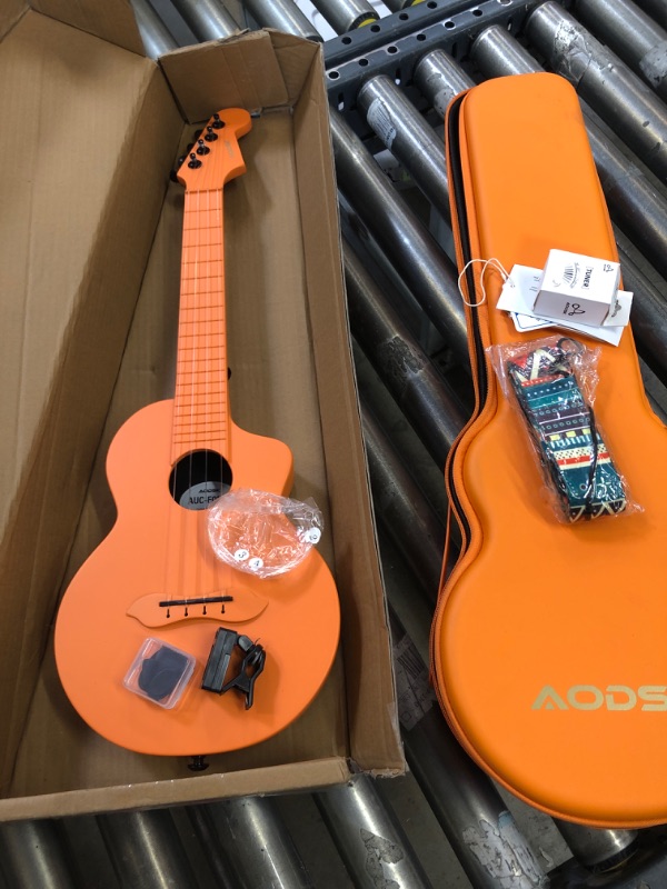 Photo 4 of Concert Ukulele for Adult Kids Beginners Kit,23inch Carbon Fiber Travel Ukulele with Beginner Kit with Case,Pick,Strap,Strings-Orange ( MINOR DIRTY CASE)