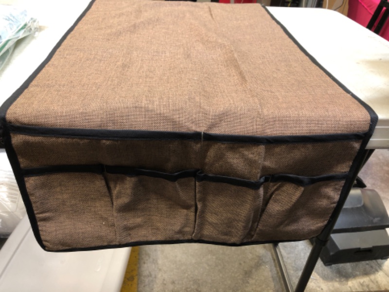 Photo 1 of umber brown fabric sheet (unknown use) slotted with multiple pockets