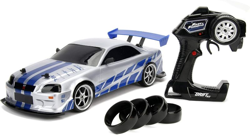 Photo 1 of Jada Toys Fast & Furious Brian's Nissan Skyline GT-R (BN34) Drift Power Slide RC Radio Remote Control Toy Race Car with Extra Tires, 1:10 Scale, Silver/Blue