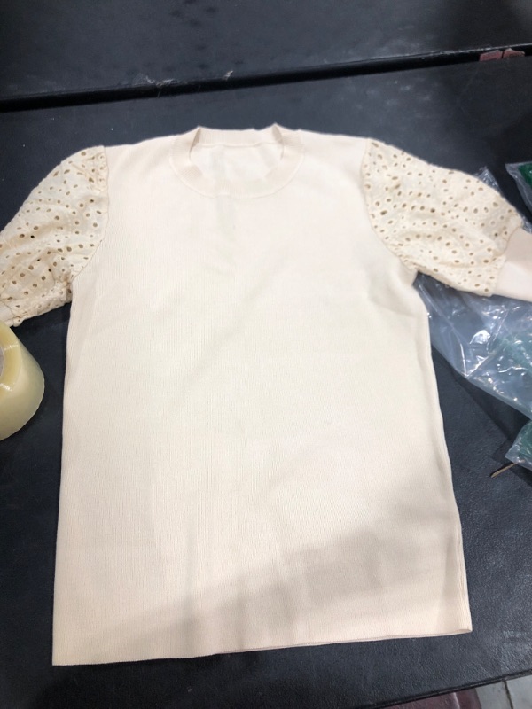 Photo 2 of  T-Shirt is an off white broderie anglaise short sleeve t-shirt with a round neck and short puffed sleeves.