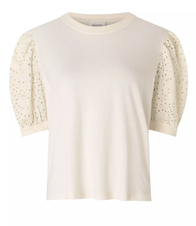 Photo 1 of  T-Shirt is an off white broderie anglaise short sleeve t-shirt with a round neck and short puffed sleeves.