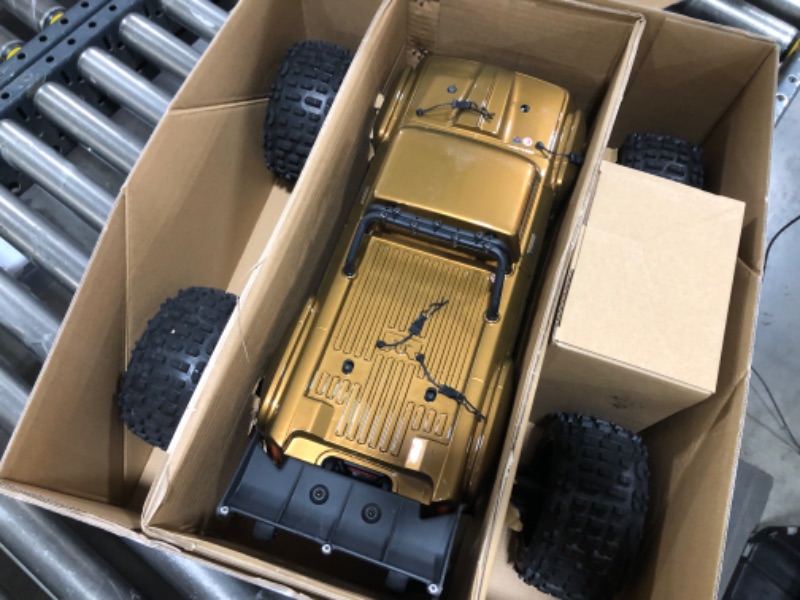 Photo 2 of ARRMA RC Truck 1/10 Outcast 4X4 4S V2 BLX Stunt Truck RTR (Battery and Charger Not Included), Bronze, ARA4410V2T1