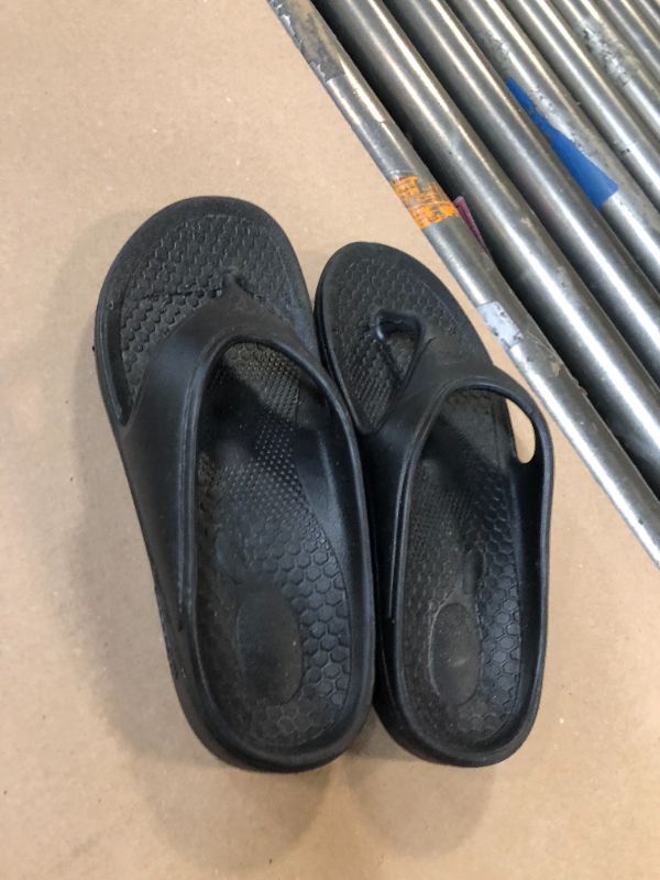 Photo 1 of black flip flops size 10