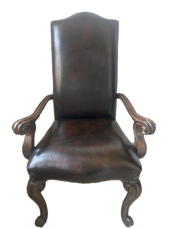 Photo 1 of LEATHER DINING ARMCHAIR WITH CROSS DETAIL ON CORNER AND STUDS EMBELISHMENT 28” x 29” x 45