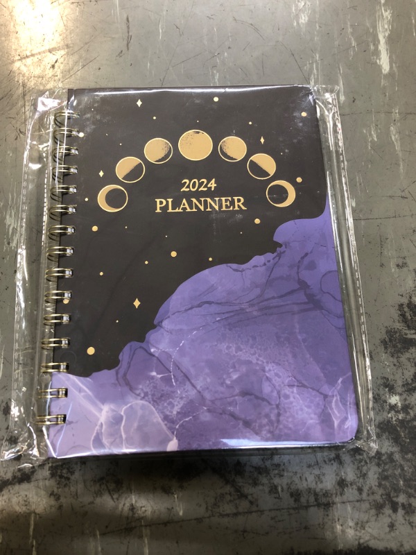 Photo 1 of 2024 planner with moon cycle cover.