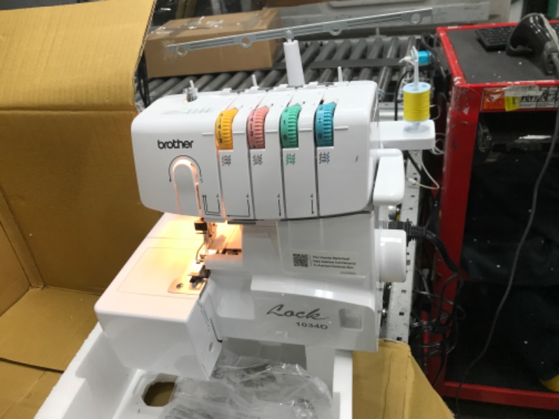 Photo 2 of **SEE NOTES/DAMAGED**
Brother Serger, 1034D, Heavy-Duty Metal Frame Overlock Machine, 1,300 Stitches Per Minute, Removeable Trim Trap, 3 Included Accessory Feet,White