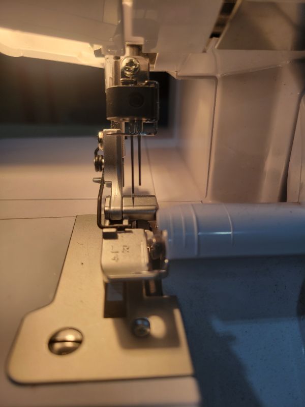 Photo 1 of **SEE NOTES/DAMAGED**
Brother Serger, 1034D, Heavy-Duty Metal Frame Overlock Machine, 1,300 Stitches Per Minute, Removeable Trim Trap, 3 Included Accessory Feet,White