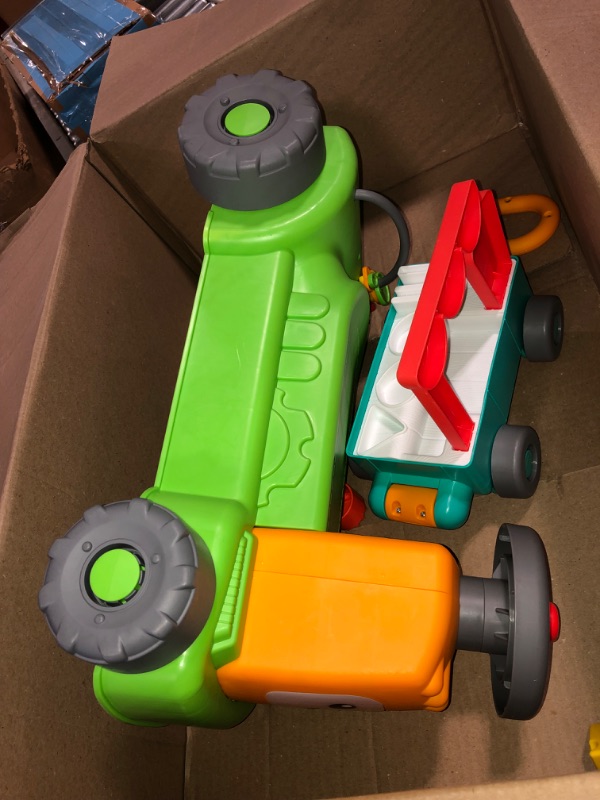 Photo 1 of Fisher-Price Laugh & Learn Baby to Toddler Toy, 4-in-1 Farm to Market Tractor Ride On with Pull Wagon & Smart Stages for Ages 9+ Months