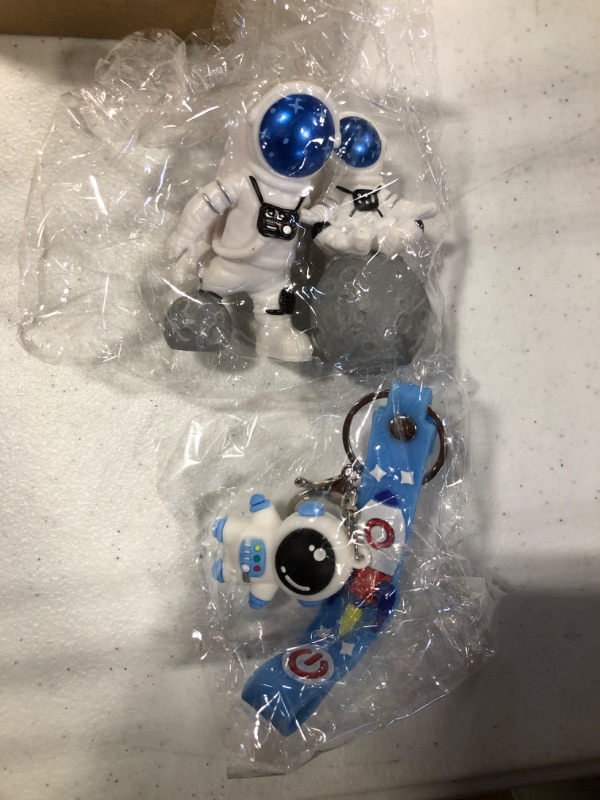 Photo 1 of 1 astronaut key chain and 2 astronaut action figures 