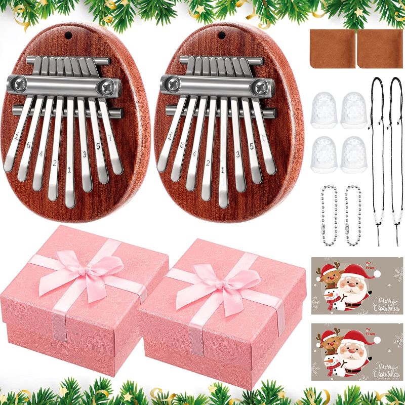 Photo 1 of 2 Set 8 Keys Mini Thumb Piano Include 2 Music Sheet 2 Christmas Card 2 Lanyard Chain 2 Cleaning Cloth 4 Finger Protector with 2 Gift Box for Kids and Adult Beginners Gift(Red)