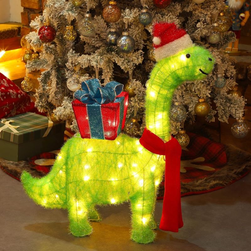 Photo 1 of  WATERGLIDE Lighted Christmas Green Dinosaur with Gift Box Decorations, 27 Inch Pre-Lit Light Up 3D Brachiosaurus Xmas Outdoor Yard Decor with Lights, for Festive Xmas Holiday Garden Lawn Display 