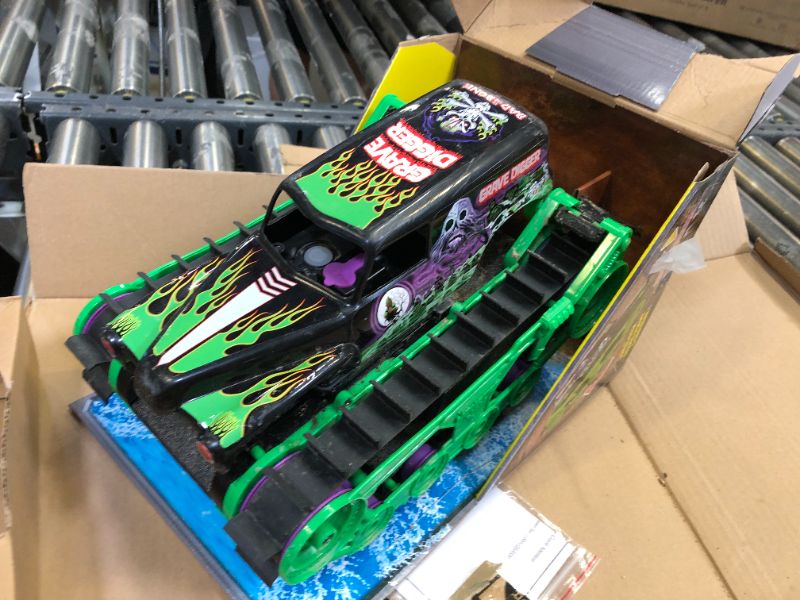 Photo 2 of Monster Jam, Official Grave Digger Trax All-Terrain Remote Control Outdoor Vehicle, 1:15 Scale, Kids Toys for Boys and Girls Ages 4 and up Grave Digger Trax (Retail Packaging)