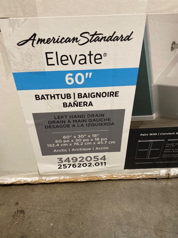 Photo 6 of American Standard Elevate 60×30 Curved Tub - Left Handed Drain - Cosmetic Damage -Apron Of Tub Has 2 Cracks Showing, 1 Small Crack On The Inside of Apron - Does Not Affect Function 
