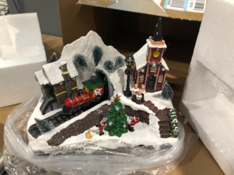 Photo 2 of Ovewios Large Christmas Village with Animated Train, Pre-lit Musical Christmas Snow Town for Christmas Party Home Tabletop Indoor Decorations Train Station