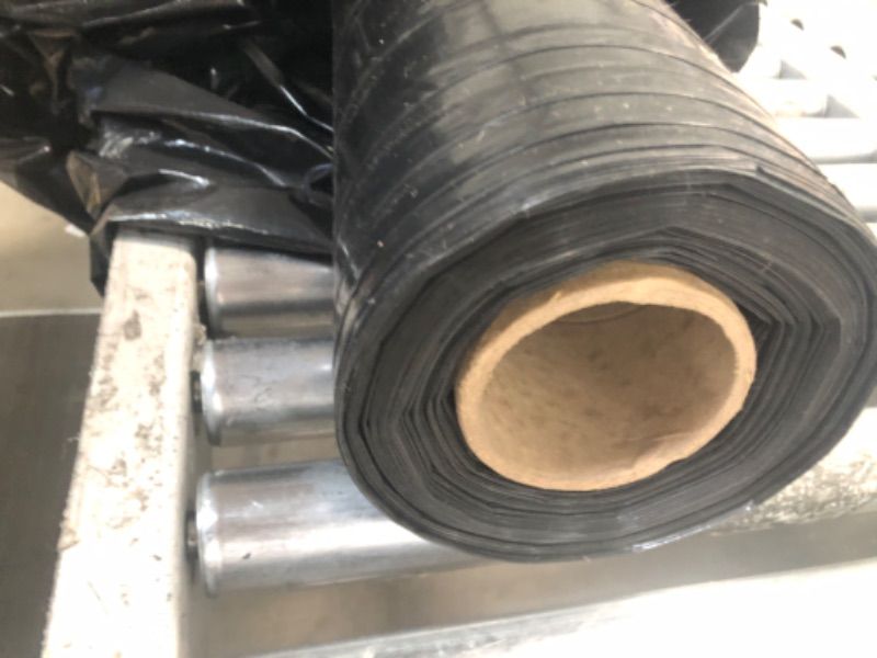 Photo 1 of 4' Wide Spool of Black Plastic Liner- Unknown Length 