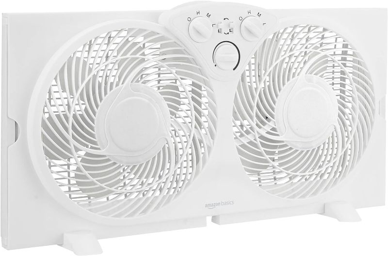 Photo 1 of Amazon Basics Window Fan with Manual Controls, Twin 9 Inch Reversible Airflow Blades, White
