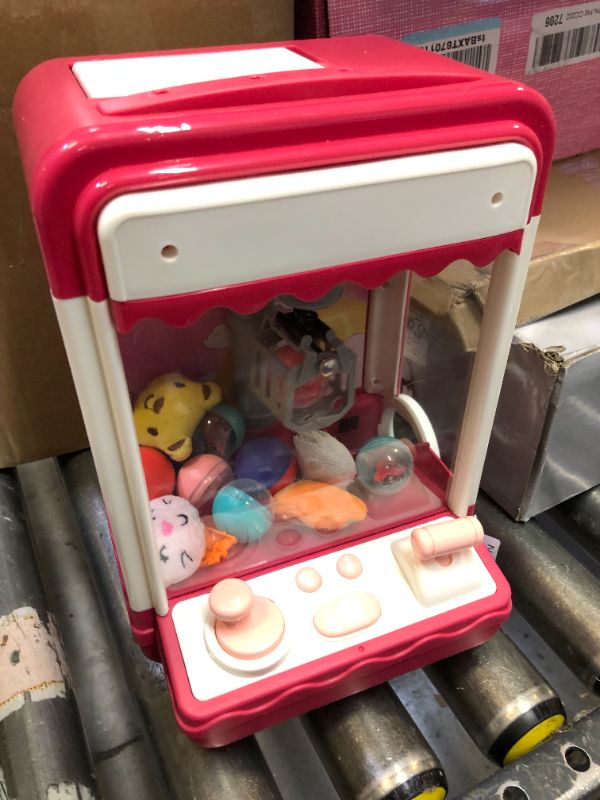 Photo 1 of HCFJEH Mini Claw Machine for Kids,Toy Vending Machine,Candy Machine for Kids with 10 Plush and 10 Egg,Electronic Arcade Claw Game Machine Toy Great Birthday Gifts for 6 7 8 9 Year Old Girl