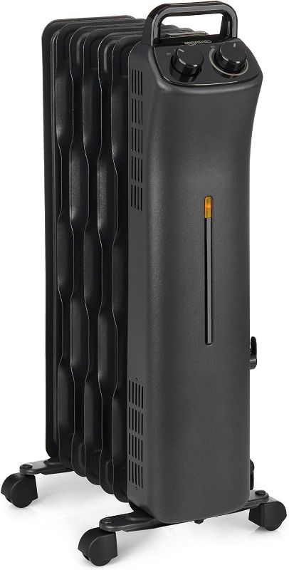 Photo 1 of Amazon Basics Portable Radiator Heater with 7 Wavy Fins, Manual Control, Black, 1500W, 13.1 x 26.3 x 9.8 in