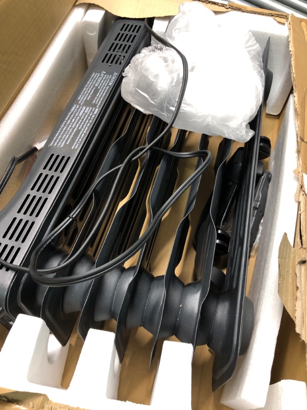 Photo 2 of **Good Used**Amazon Basics Portable Radiator Heater with 7 Wavy Fins, Manual Control, Black, 1500W, 13.1 x 26.3 x 9.8 in