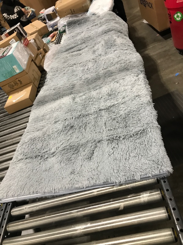 Photo 1 of 9' x 6' area rug -- color grey 