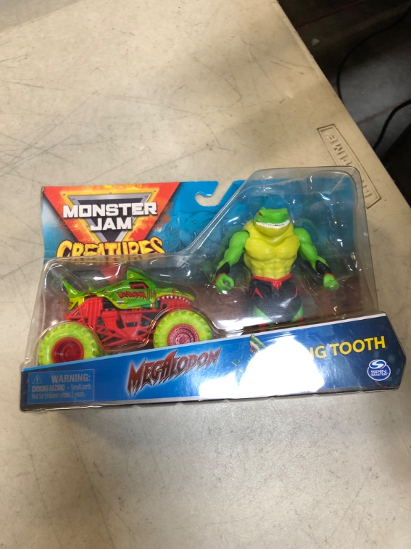 Photo 2 of Monster Jam, Official Megalodon 1:64 Scale Monster Truck and 5-inch Big Tooth Creatures Action Figure (Zombie Green) Megalodon & Zombie Green