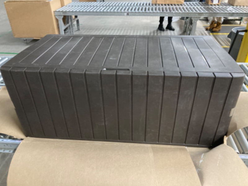 Photo 1 of ***MINOR DAMAGE, SEE NOTES*** Keter Marvel Plus 71 Gallon Resin Deck Box-Organization and Storage for Patio Furniture Outdoor Cushions, Throw Pillows, Garden Tools and Pool Toys, Brown
 Exterior: 45. 9 in. W x 17. 4 in. D x 22. 2 in. H / Interior: 44. 6 i