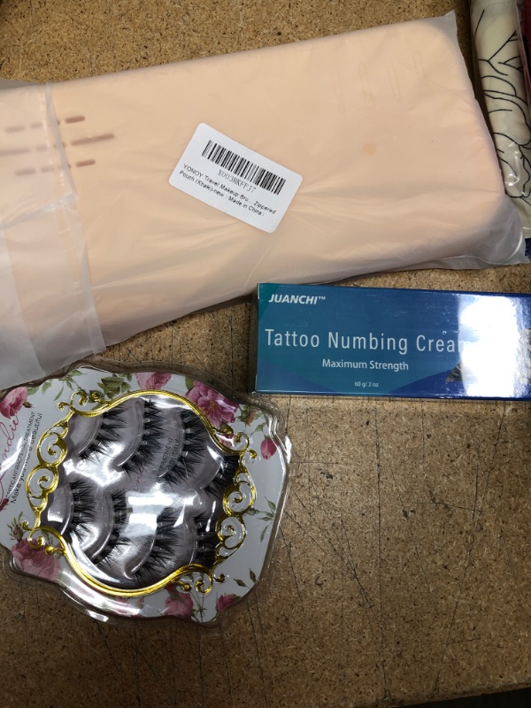 Photo 1 of 3 beauty items: silicone pouch, tattoo numbing cream, and set of lashes