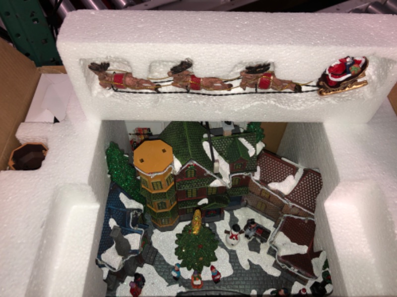 Photo 2 of * DAMAGED READ NOTES*Christmas Village Centerpiece Decor, Santa Riding in Sleigh, with Christmas Tree and Village Buildings, Featuring LED Lights, Christmas Music, and Animation Power Adapter Included