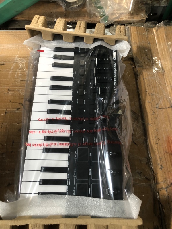 Photo 1 of M-Audio Oxygen Pro Mini – 32 Key USB MIDI Keyboard Controller With Beat Pads, MIDI assignable Knobs, Buttons & Faders and Software Suite Included 32 Mini Keys MIDI Keyboard Only