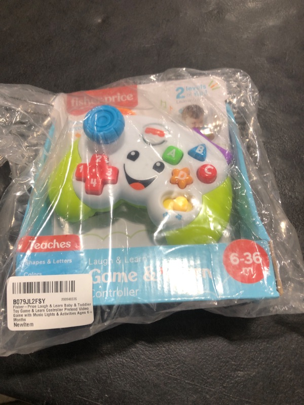 Photo 2 of Fisher-Price Pretend Video Game Controller Baby Toy with Music Lights and Learning Songs, Fine Motor Toy Standard