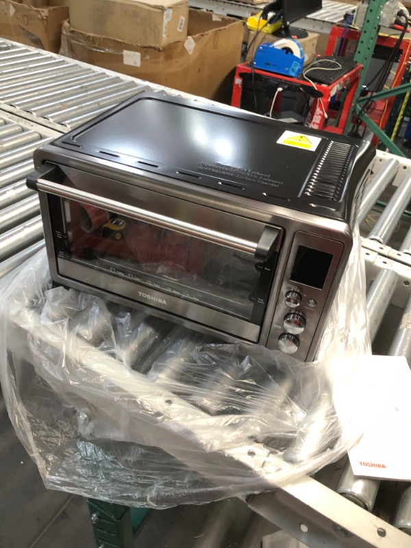 Photo 2 of **dented on the side powers on** TOSHIBA AC25CEW-BS Large 6-Slice Convection Toaster Oven Countertop, 10-In-One with Toast, Pizza and Rotisserie, 1500W, Black Stainless Steel