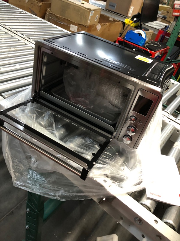 Photo 3 of **dented on the side powers on** TOSHIBA AC25CEW-BS Large 6-Slice Convection Toaster Oven Countertop, 10-In-One with Toast, Pizza and Rotisserie, 1500W, Black Stainless Steel