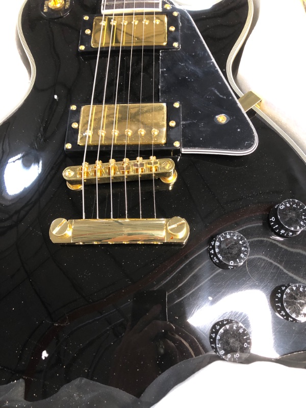 Photo 2 of ***USED - LIKELY MISSING PARTS - UNABLE TO VERIFY FUNCTIONALITY***
Hefagita Solid Electroic Guitar, Black, Gold Colored Accents, 40.5 x 14.75 x 4.5 inches