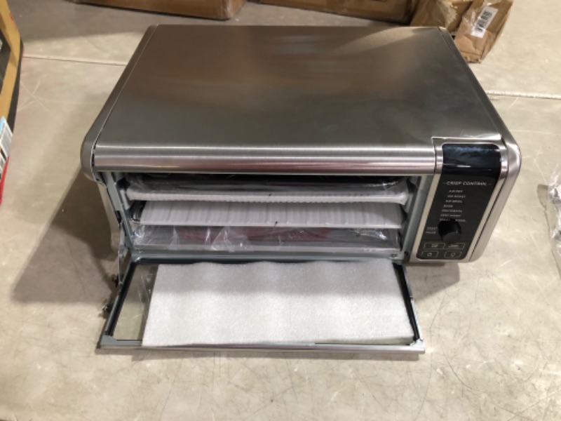 Photo 6 of ***MAJOR DAMAGE - SEE COMMENTS***
Ninja SP101 Digital Air Fry Countertop Oven with 8-in-1 Functionality, Flip Up & Away Capability for Storage Space, with Air Fry Basket, Wire Rack & Crumb Tray, Silver