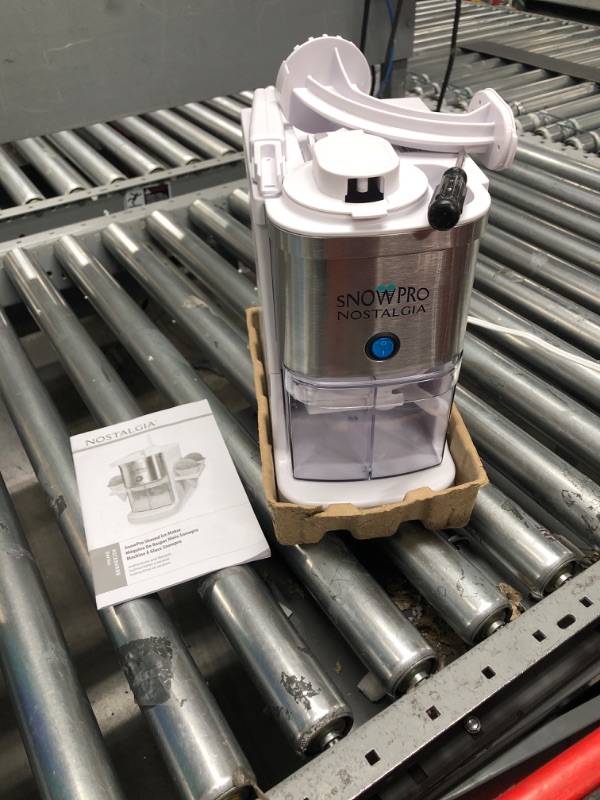 Photo 2 of (TESTED)Nostalgia SnowPro Electric Shaved Ice & Snow Cone Maker 64-Ounce Ice Shaving Capacity, 4 Reusable Cones, Side Shelves, and Scoop Included Snow Pro