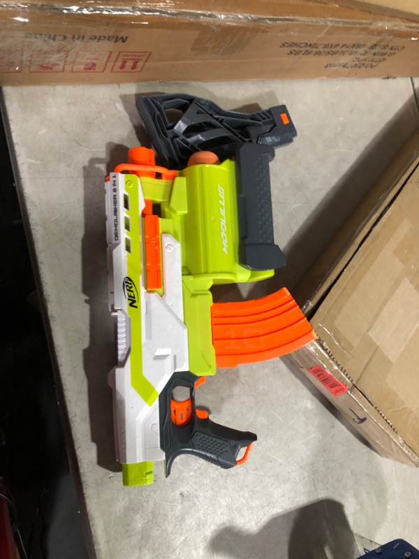 Photo 1 of ***USED - NO DARTS INCLUDED - UNABLE TO TEST***
NERF Modulus Demolisher 2-in-1 Motorized Blaster, Fires Darts and Rockets, Includes 10 Elite Darts, Banana Clip, 2 Rockets, Stock (Amazon Exclusive)